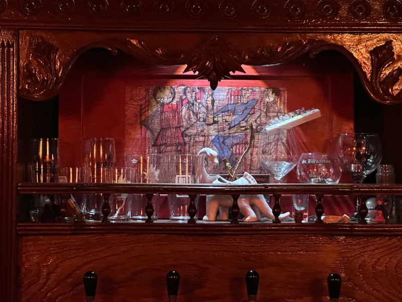 Ornate backbar detail at Sigilo Porto with glassware and artwork
