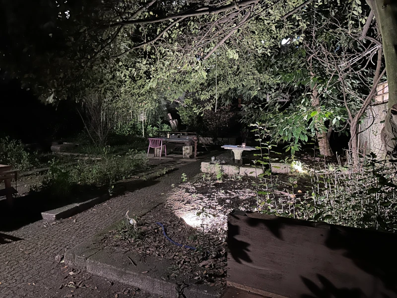 Hidden garden patio at Sigilo Porto at night