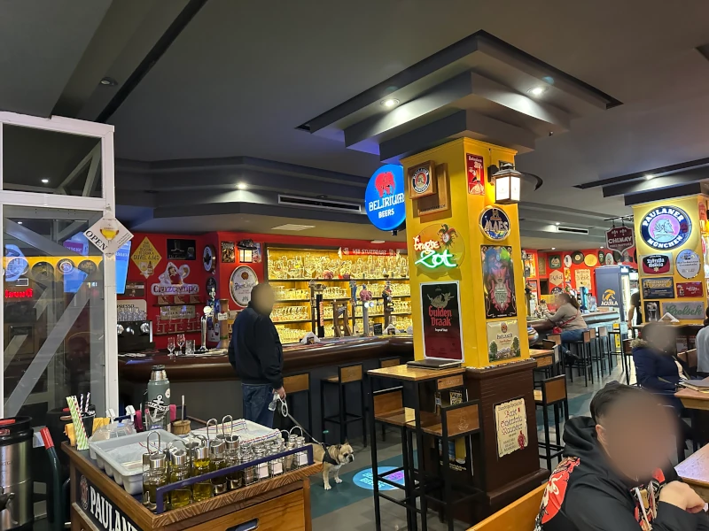 Interior of Cervecería Untertürkheim Málaga with Delirium and Paulaner signage