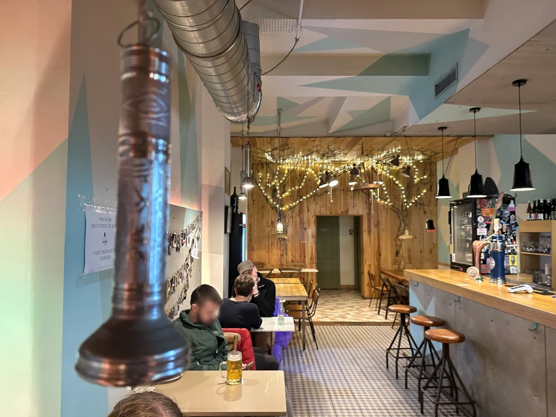 Main bar room at La Linterna Ciega Sevilla with fairy lights and murals